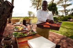 solio-lodge-Safari-living-Setting-up-for-lunch-in-the-dining-platform